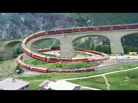 Swiss train in Brusio spiral loop railway viaduct, Switzerland, 2k18 | shock wave